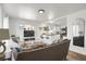 Open-concept living room showcasing a seamless flow into the modern kitchen and eating area at 6896 Ruth Way, Denver, CO 80221