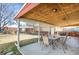 Covered outdoor patio with ample seating, perfect for entertaining and relaxing at 6896 Ruth Way, Denver, CO 80221