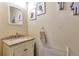 Cozy bathroom featuring a vanity sink, neutral decor, and stylish mirror at 2079 S Quintero St, Aurora, CO 80013