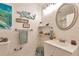 This bathroom features a white vanity, and turquoise themed decor at 2079 S Quintero St, Aurora, CO 80013
