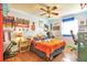 This colorful bedroom has wood floors, ceiling fan, and plenty of natural light at 2079 S Quintero St, Aurora, CO 80013