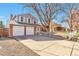 Attractive home with a two-car garage, brick facade, and a spacious driveway at 2079 S Quintero St, Aurora, CO 80013
