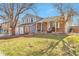 Lovely front exterior with brick accents, a manicured lawn, and a cozy front porch at 2079 S Quintero St, Aurora, CO 80013