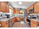 Bright kitchen showcases wood cabinets, stainless appliances, and open layout to dining area at 2079 S Quintero St, Aurora, CO 80013