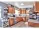 Charming kitchen with wood cabinets, stainless steel appliances, and a cozy coffee bar at 2079 S Quintero St, Aurora, CO 80013