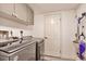 Functional laundry room with modern washer and dryer, plus ample storage space at 2079 S Quintero St, Aurora, CO 80013
