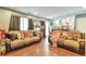 Comfortable living room with movie decor, wood floors, and open access to the upper level at 2079 S Quintero St, Aurora, CO 80013