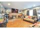 Spacious living room with brick fireplace, movie decor, and comfortable sofa for relaxing at 2079 S Quintero St, Aurora, CO 80013
