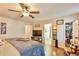 This bedroom features a walk-in closet and en suite bathroom with wood floors and ample natural light at 2079 S Quintero St, Aurora, CO 80013