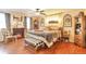 Cozy main bedroom featuring a fireplace, tray ceiling, wood floors, and modern décor at 2079 S Quintero St, Aurora, CO 80013