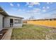 Backyard featuring lush green grass, a newly constructed fence, and a screened in patio at 235 N 12Th Ave, Brighton, CO 80601