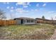 Backyard featuring lush green grass, a newly constructed fence, and a screened in patio at 235 N 12Th Ave, Brighton, CO 80601
