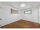 Bright bedroom with hardwood floors and two windows at 235 N 12Th Ave, Brighton, CO 80601