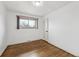 Minimalist bedroom with hardwood floors, a window, and white walls at 235 N 12Th Ave, Brighton, CO 80601