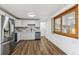 Bright kitchen with white cabinets, stainless steel appliances, and a large window providing ample natural light at 235 N 12Th Ave, Brighton, CO 80601