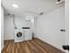 A modern laundry room with a washer and dryer, new flooring and white walls at 235 N 12Th Ave, Brighton, CO 80601
