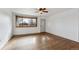 Bright living room with hardwood floors, a ceiling fan, and a large window with a view at 235 N 12Th Ave, Brighton, CO 80601