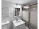 Bathroom with a marble vanity, patterned shower doors and modern lighting at 10248 Quivas St, Thornton, CO 80260