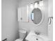 Bathroom featuring a single sink vanity, white walls, and a mounted cabinet at 10248 Quivas St, Thornton, CO 80260