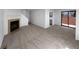 Inviting living room featuring a classic fireplace and large sliding glass doors for abundant natural light at 10248 Quivas St, Thornton, CO 80260