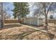 A spacious backyard with a shed, a large tree, and a privacy fence at 1248 Moline St, Aurora, CO 80010