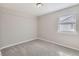 This empty bedroom has neutral paint, plush carpet, natural light, and a window at 1248 Moline St, Aurora, CO 80010