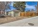 View of the detached garage and wooden fence, providing a private parking space and security at 1248 Moline St, Aurora, CO 80010