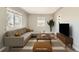 Bright living room featuring a neutral color scheme, large sectional sofa, and modern decor at 1248 Moline St, Aurora, CO 80010