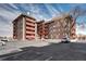 Well-maintained apartment building with red balconies and on-site parking available for tenants at 3047 W 47Th Ave # 110, Denver, CO 80211