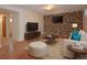 Stylized basement with wood-look floors, stone accent wall, and comfortable seating area at 8750 Rutgers St, Westminster, CO 80031
