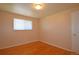 A bright bedroom showcases hardwood flooring and a window at 8750 Rutgers St, Westminster, CO 80031