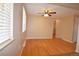 Bright living room featuring hardwood floors, a ceiling fan, and large windows at 8750 Rutgers St, Westminster, CO 80031