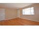 Spacious living room featuring hardwood floors and a large window for natural light at 8750 Rutgers St, Westminster, CO 80031