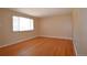 Bright and airy living room features gleaming hardwood floors and a large window at 8750 Rutgers St, Westminster, CO 80031