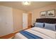 A beautifully staged bedroom with hardwood floors, a bed and two side tables at 8750 Rutgers St, Westminster, CO 80031