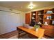 Stylized office space with wood-look floors, closet, and custom wood shelving at 8750 Rutgers St, Westminster, CO 80031