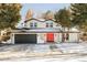 Stunning contemporary home with a red door and attached garage at 4072 S Quebec St, Denver, CO 80237