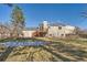 House backyard view with deck and grassy area at 9150 W Bellwood Pl, Littleton, CO 80123