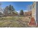 Spacious backyard with a deck and mature trees at 9150 W Bellwood Pl, Littleton, CO 80123