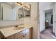 Simple bathroom with vanity, sink, and medicine cabinet at 9150 W Bellwood Pl, Littleton, CO 80123