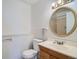 Basement bathroom with toilet, sink, and vanity at 9150 W Bellwood Pl, Littleton, CO 80123