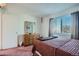 Bright bedroom featuring a double bed, dresser, and window coverings at 9150 W Bellwood Pl, Littleton, CO 80123