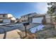 Tan two-story house with attached garage and mailbox at 9150 W Bellwood Pl, Littleton, CO 80123