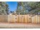 Wooden fence with double gates leading to the backyard at 9150 W Bellwood Pl, Littleton, CO 80123