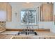 Kitchen with wooden cabinets and a double sink at 9150 W Bellwood Pl, Littleton, CO 80123