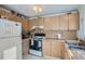 Kitchen with wooden cabinets, double sink, and window at 9150 W Bellwood Pl, Littleton, CO 80123