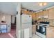 Kitchen with wooden cabinets, electric range, and refrigerator at 9150 W Bellwood Pl, Littleton, CO 80123