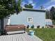 Exterior shot of backyard with a hot tub, adjacent deck, blue siding and green lawn at 1158 E Easter Ct, Centennial, CO 80122