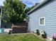 Landscaped backyard featuring a hot tub, lush lawn, flowers and blue siding at 1158 E Easter Ct, Centennial, CO 80122