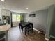 Open dining area featuring a dark wood table, natural light, and hardwood floors at 1158 E Easter Ct, Centennial, CO 80122